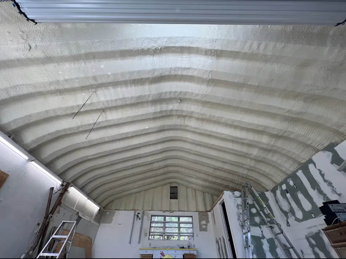 Spray polyurethane foam applied to the underside of a metal roof deck in Waltham